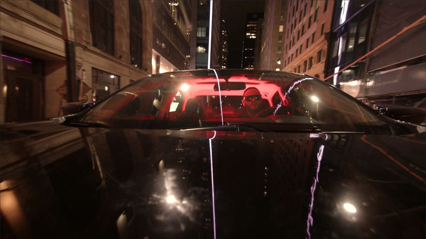 A cinema camera tracking along the side of a car during an automotive shoot